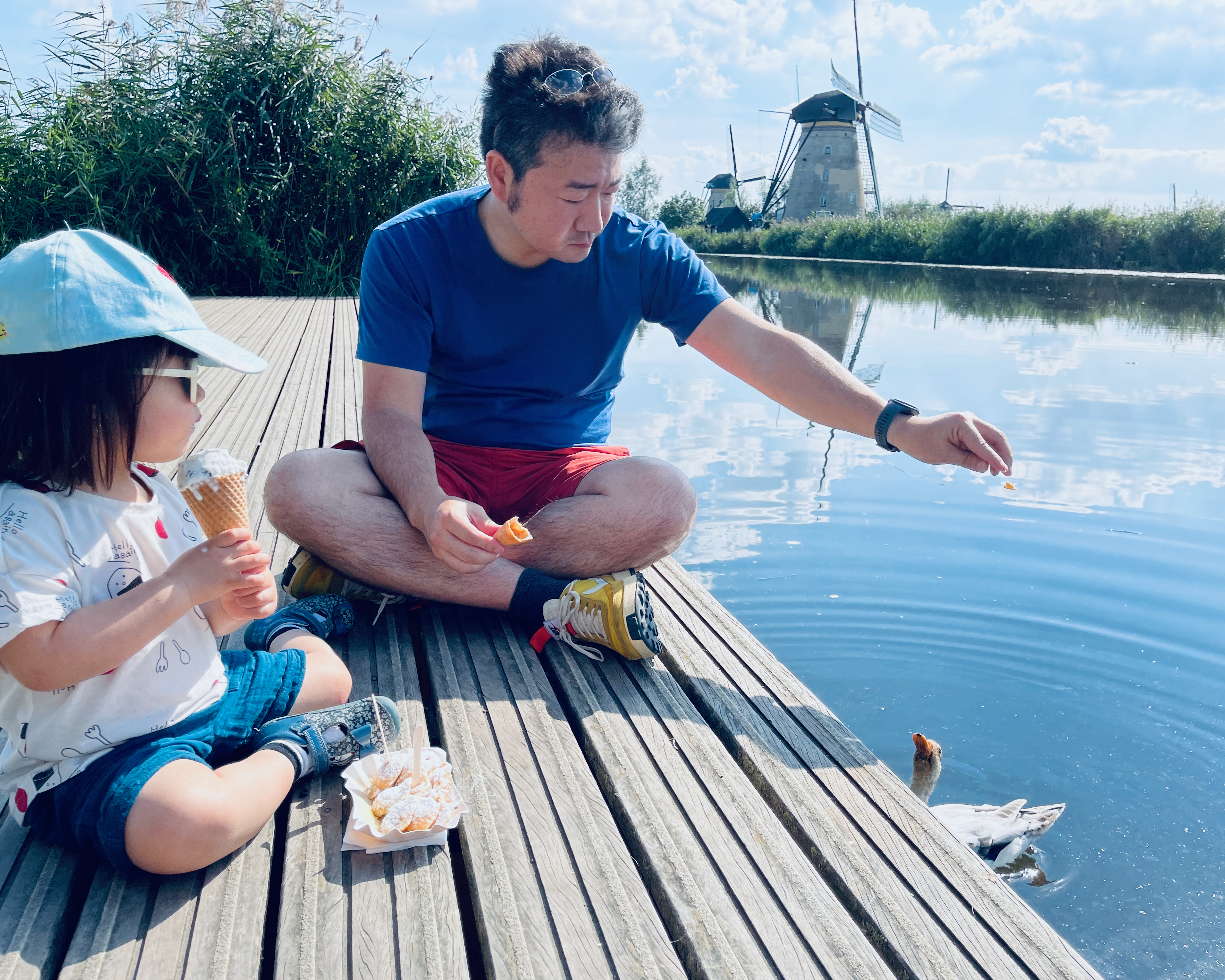 Shinta spending time with his daughter beside a canal in the Netherlands